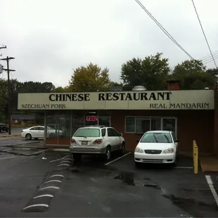 two cars parked in front of the restaurant