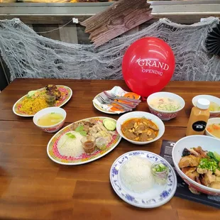 a wooden table with plates of food on it