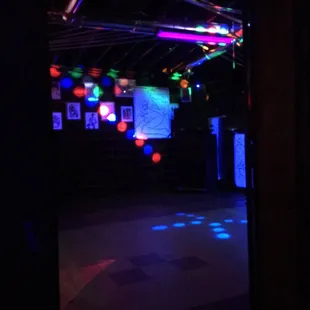 a dark room with neon lights
