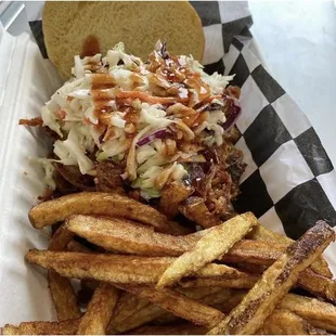 Pulled pork sandwich with coleslaw and fresh cut fries