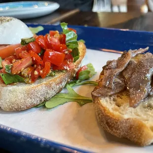 a plate of sandwiches with meat and vegetables