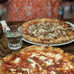 two pizzas on a table