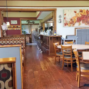 The interior, with booths, tables and the counter with stools.