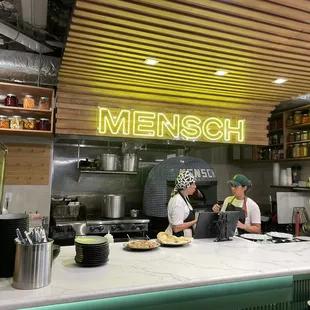 three chefs preparing food in a restaurant