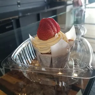 a cupcake with a strawberry on top
