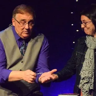 Phoenix magician, Rod Robison, performs his show Mentallusions, with audience member on stage.