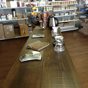 a long table with cups and plates on it