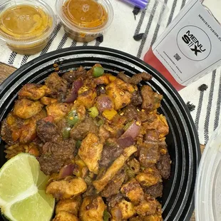 Combo bowl with beef, chicken, veggies and jollof rice. Portion size was great. Plenty for a couple meals or sharing.