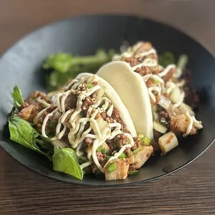 Hanabi Chashu Buns: Two soft buns w/kimista cubes &amp; spicy minced pork. Topped w/Japanese mayonnaise, chives, onion, &amp; green onions | $8.49