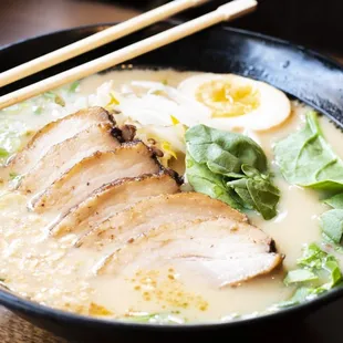 a bowl of ramen and chopsticks