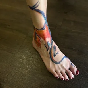 Watercolor ankle dragon. The other wing wraps around to the other side.