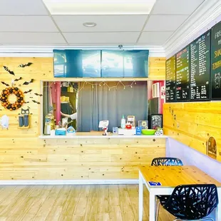 a wooden counter with a blackboard on the wall