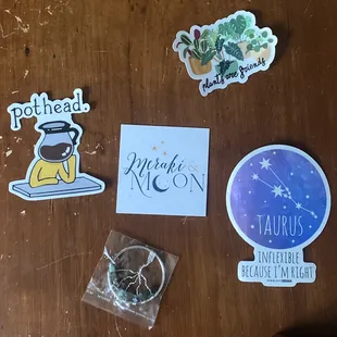 front of business card, three stickers, and a tree of life accessory.