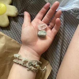 a light blue stone bracelet and two crystals.