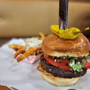 a cheeseburger with pickles on top