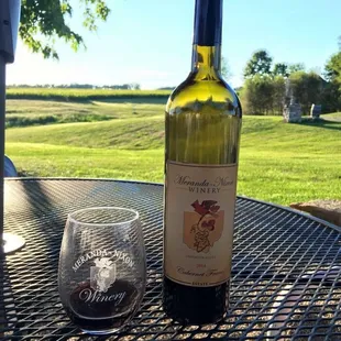 a bottle of wine and a glass on a table