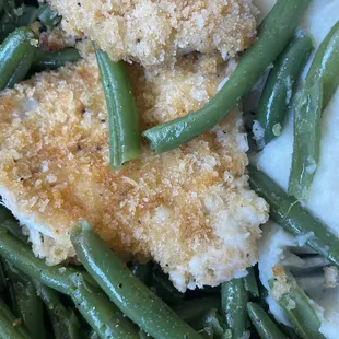 a plate of green beans and fried chicken