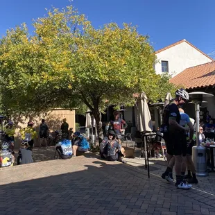 a group of people sitting outside a restaurant