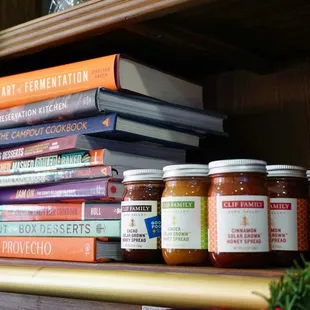 a shelf of books and jars of preserves