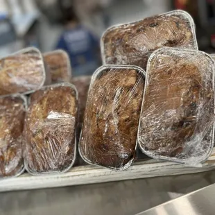 a tray of bread wrapped in plastic