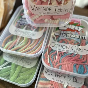 a variety of candies in plastic containers