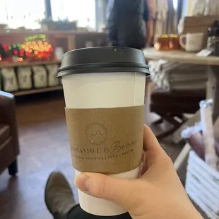 a person holding a cup of coffee