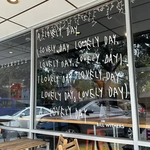 the window of a coffee shop with writing on the glass