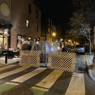 people walking on a city street at night