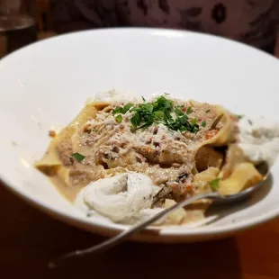 a bowl of pasta with meat and cheese