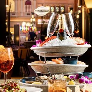 Seafood Tower: Half/ Whole Maine Lobster, East Coast Oysters, Poached Tiger Prawns, Salmon Tartare, Cocktail Sauce, Mignonette, Horseradish.