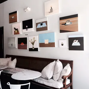 a living room with a couch, table, and pictures on the wall