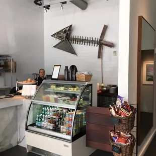 a woman behind the counter of a deli