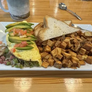 Veggie omelet (no cheese, but added ham) with home fries and GF toast.