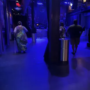 people walking down the hall