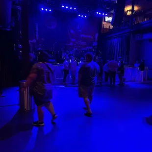 a group of people dancing in a dark room