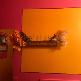 a vase of flowers on a shelf
