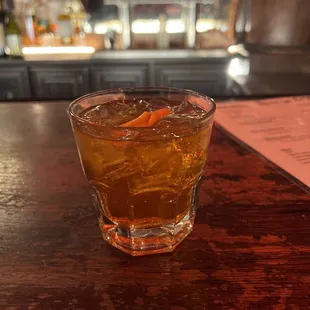 a drink in a glass on a bar