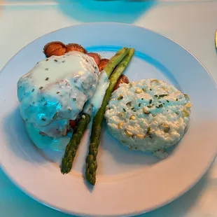 Crab cake atop a cold water lobster tail, with asparagus and corn risotto