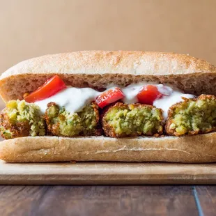 Delicious falafel sandwich with lettuce, tomatoes, tahini sauce. Comes with Tots!
