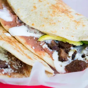 Baleadas con asada hand made flour tortilla with beans,cheese,avocado,sour cream, and grill beef