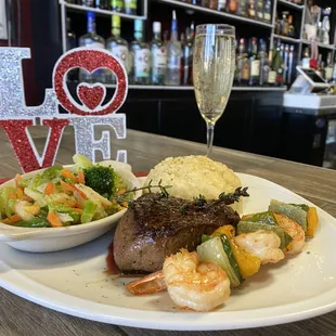 a plate of food and a glass of wine