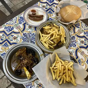 Lamb prune tagine &amp; fries, chicken lemon olive  fresh baked Moroccan bread and the famous merguez (spicy lamb sausage)