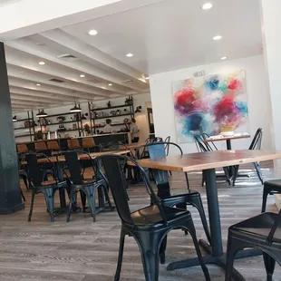 a dining area with tables and chairs