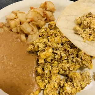 Huevos Con Chorizo plate with corn tortillas.