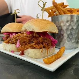 a pulled pork sandwich and french fries