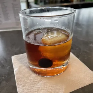 a drink in a glass on a napkin