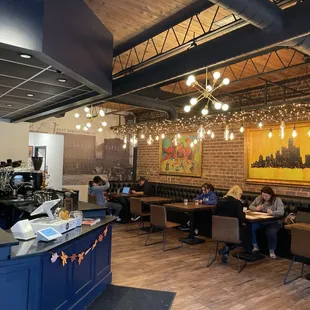 people sitting at tables and working on laptops