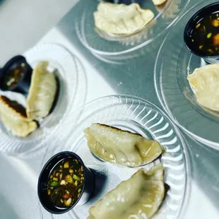 a variety of dumplings and dipping sauces