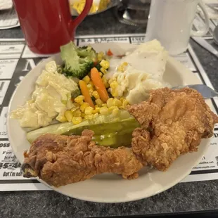 a plate of fried chicken and vegetables