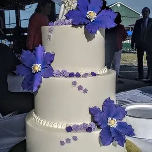 a bride and groom on top of a wedding cake